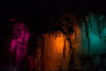 Multi-coloured lights illuminate the cavern, giving it a magical atmosphere