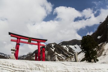Yudono-san is still caked in snow during spring but its mysterious air and final destination is worth the walk up