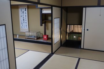 One of the fusuma (paper doors) has a little secret behind it, a window that looks down at the sake brewery work-space
