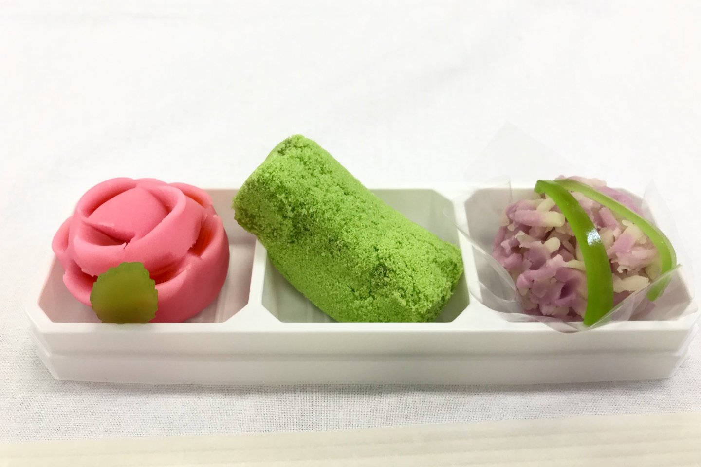 Seasonal rose and hydrangea wagashi, with a mossy stone in the middle!