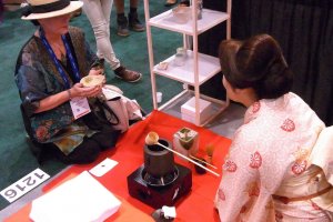 Rie Takeda, founder of Chazen, serving tea to a visitor at the World Tea Expo (U.S.)