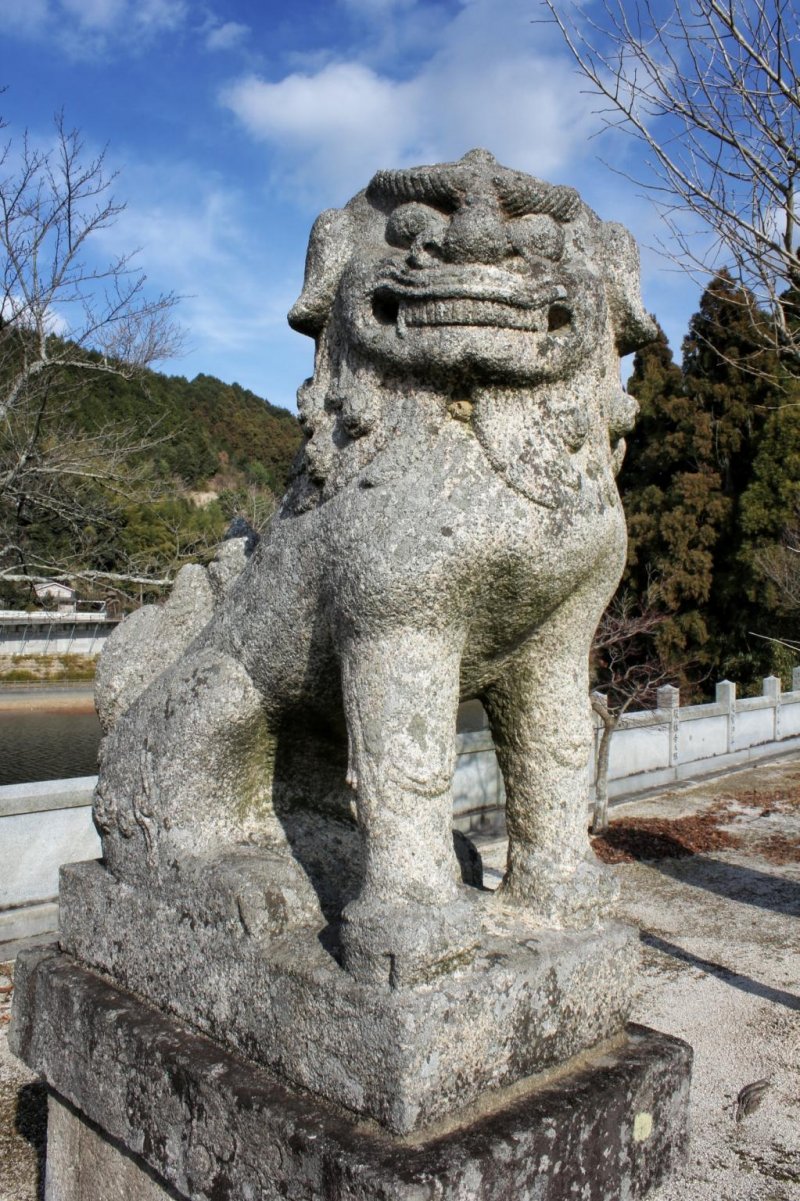One of the stone lion-dogs guarding the shrine
