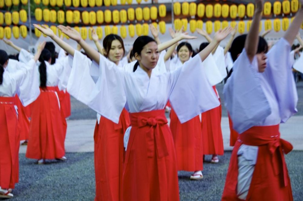 100 local ladies become shrine maidens for the evening to dance in at Hiroshima Gokoku-jinja Shrine