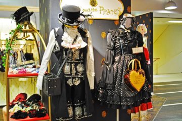 Gothic lolita outfits on display.
