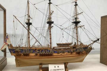 Intricately detailed model ships on display.