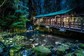The magical portal bridge of Akiyoshi Cave spans the Ina River and leads you into an underground adventure