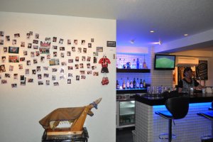 A jamón ibérico leg next to a wall filled with guest's pictures