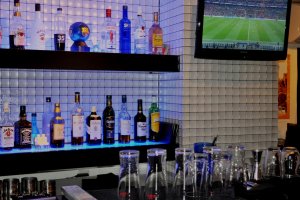 Drinks and small TV behind the bar
