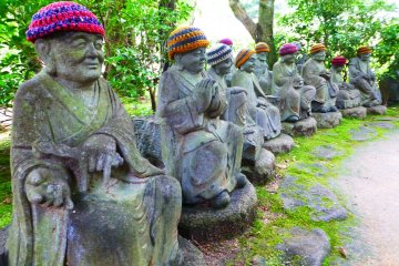 To the left of the steps leading up the temple you will find a path which winds through a multitude of jizo statues