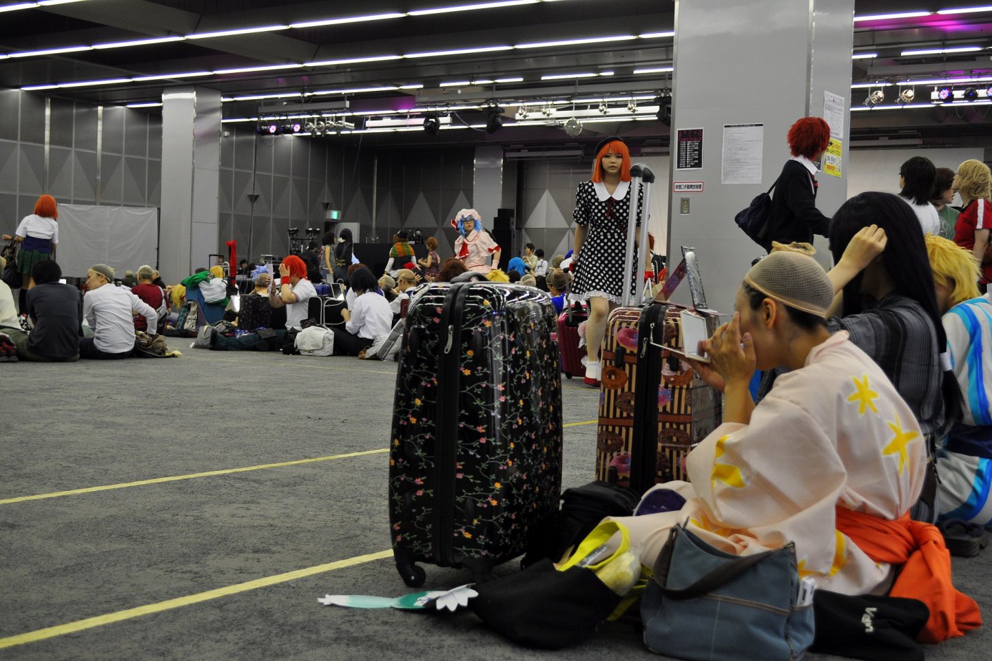Behind the scenes, cosplayers get ready at Prism Hall before prancing around Tokyo Dome City