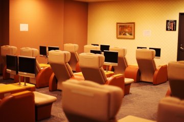 The hotel's relaxation room: comfy chairs and personal televisions.