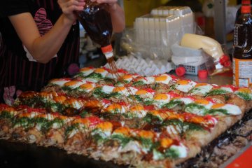 Okonomiyaki getting the sauce treatment