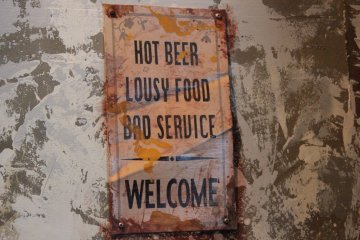 Contrary to the joking sign, their drinks are cold, the food is hot, and their service is lovely. The photo is just to show they have a good sense of humor!