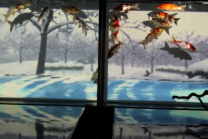 THE FOUR SEASONS AQUARIUM: feauturing a scroll of rotating seasonal images serving as a backdrop for the swimming goldfish.