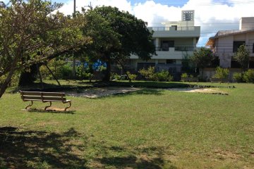 <p>These few benches and the tire surrounded sand pit are the only iindicators that Sukubu Koen is a park</p>