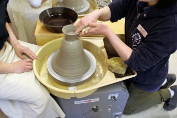 Working the clay on the potter's wheel