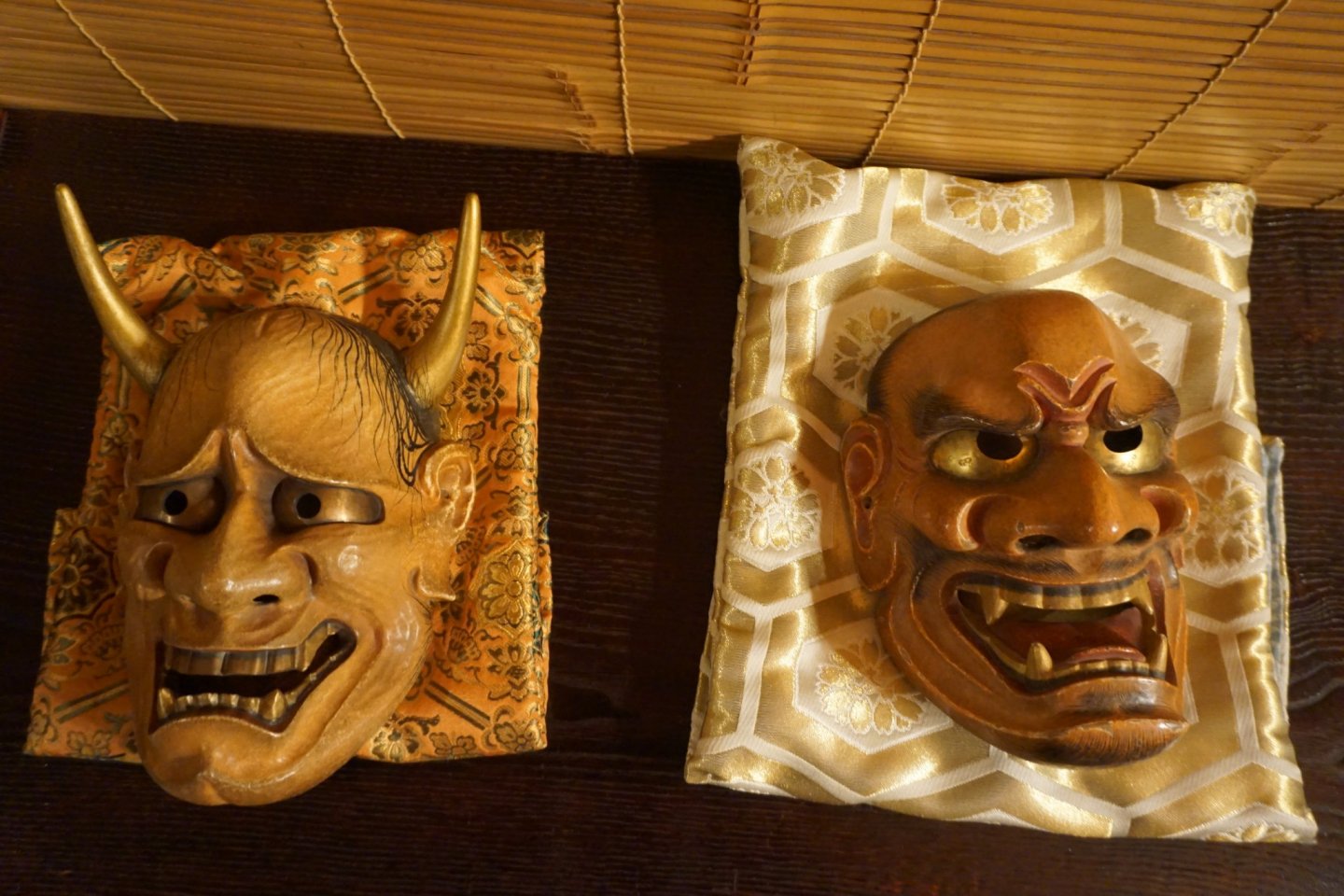 Wooden masks depicting a female demon (left) and an ogre (right)