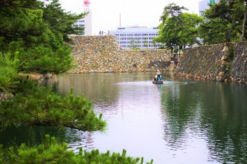 A wooden boat working the moat