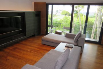 Villa lounge area with forest-facing balcony