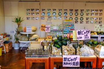 The rear wall of the market displays pictures and information of each farm