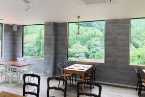 The cafe's large windows open up to the stunning nature outside