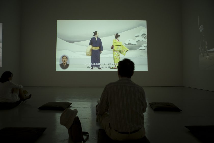 A gallery patron views one of the films on display