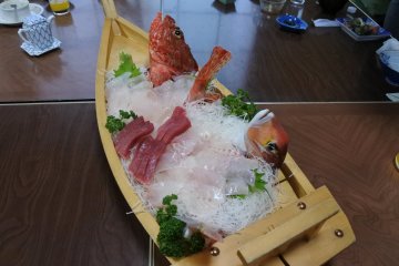 Fresh sashimi served in a traditional and elaborate sashimi boat.