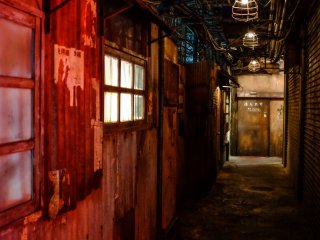 You’re immediately immersed in a dark and dingy alleyway constructed with the look and feel of the original Kowloon Walled City