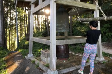Ringing the temple bell at sunrise