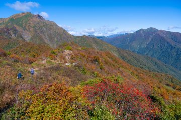 People hiking around Mt. Tanigawa surrounded in early autumn colors