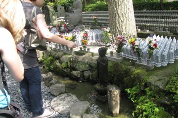 Pouring water to Jizo statue