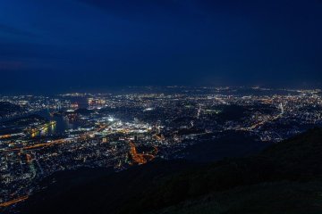 Kitakyushu lights up at dusk, seen from Mt. Sarakura