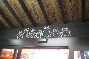 Don't miss these tanuki above the front door!