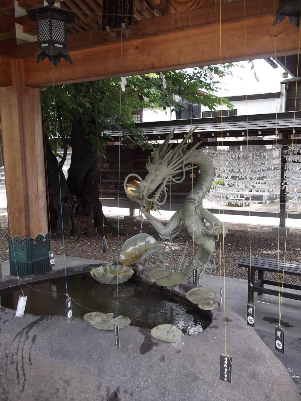 A fierce-looking dragon will watch you purify your hands