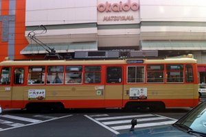 A tram rattles out from the Okaido stop