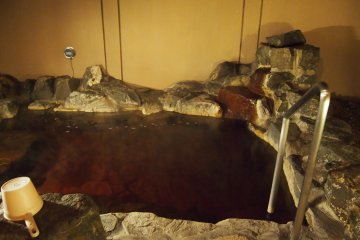 The steaming rotenburo (outdoors onsen) with natural spring water.