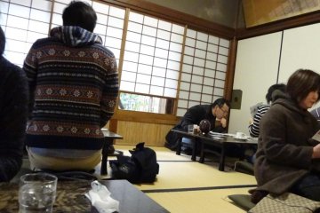 There are floor tables spread around a tatami mat room.