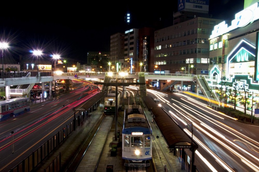 Light trails of the traffic passing on both sides of Nagasaki-Ekimae station at night