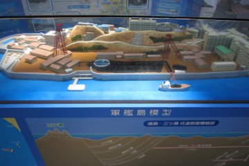 There is a model 'Gunkanjima' displayed inside the Terminal Building