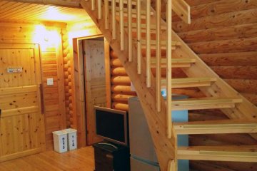 <p>Inside the log cabin. In this cabin, two beds are downstairs, and four upstairs. There is also a living room area, bathroom and separate shower.</p>