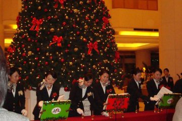 Hotel Nikko Tokyo employees performing in the lobby on Christmas Eve.